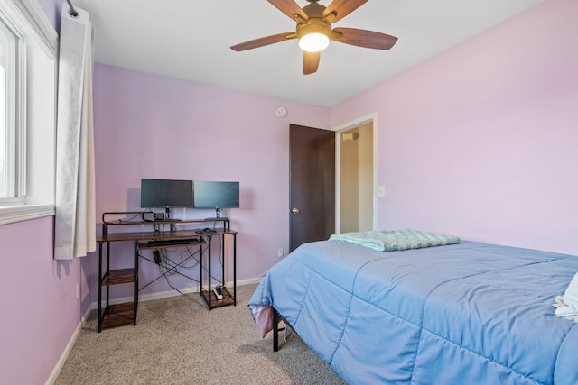 carpeted bedroom featuring baseboards and ceiling fan