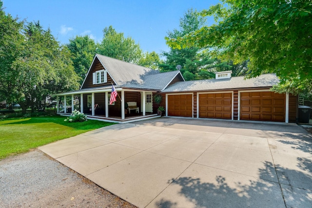 view of front facade with a garage, covered porch, concrete driveway, and a front yard