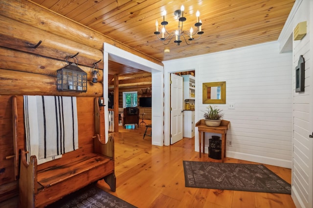 interior space with a chandelier, hardwood / wood-style floors, rustic walls, and wood ceiling