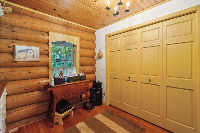 bedroom with wooden ceiling, a chandelier, a closet, and wood finished floors