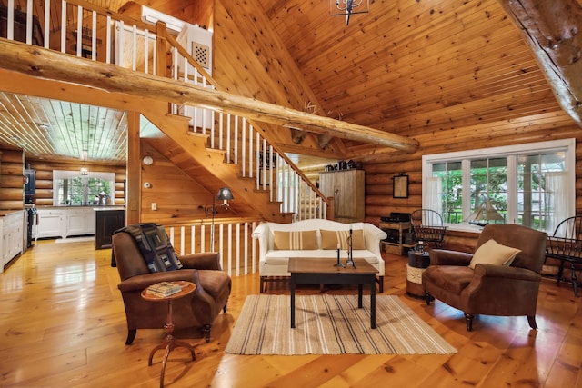 living room featuring stairs, light wood-type flooring, wooden ceiling, and a healthy amount of sunlight