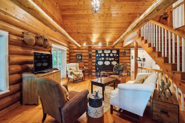 living area featuring high vaulted ceiling, stairway, light wood-type flooring, and wooden ceiling