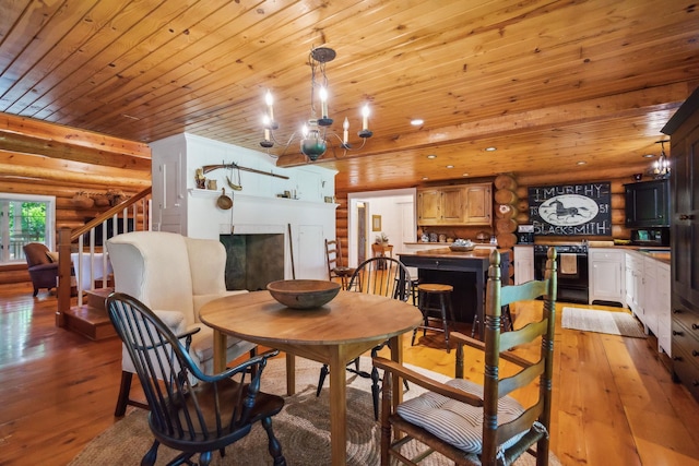 dining area featuring wooden ceiling, light wood-style flooring, stairway, log walls, and a fireplace