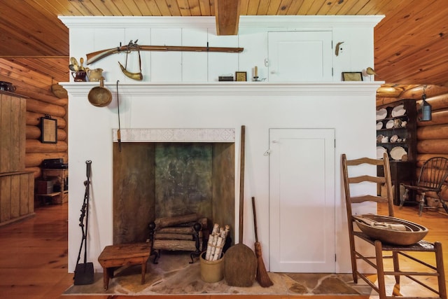 interior space featuring wooden ceiling, log walls, wood finished floors, and beamed ceiling