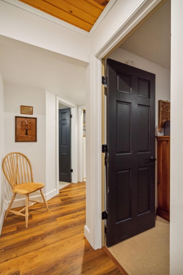 hallway with baseboards and wood finished floors