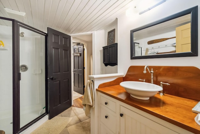 bathroom with wooden ceiling, tile patterned floors, vanity, and a stall shower