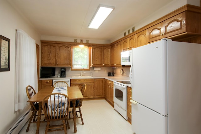 21 1st St NE, Fairfax, MN 55332 - kitchen with white appliances, a baseboard heating unit, light countertops, and brown cabinetry