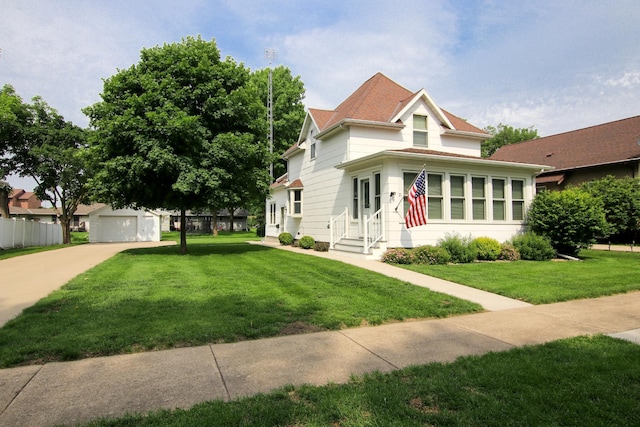 21 1st St NE, Fairfax, MN 55332 - victorian home featuring a front lawn, an outdoor structure, driveway, a garage, and entry steps