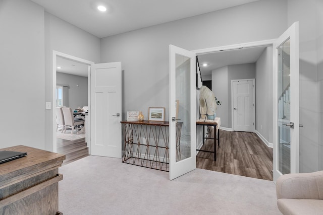 corridor with carpet floors, recessed lighting, french doors, and baseboards