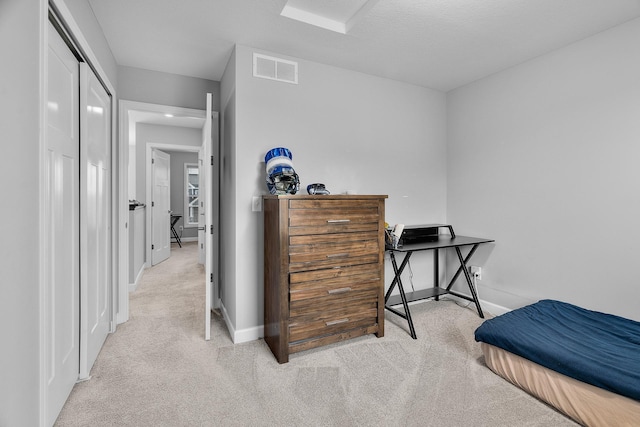 carpeted bedroom with baseboards and visible vents