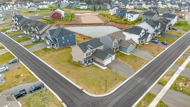 bird's eye view with a residential view and a water view