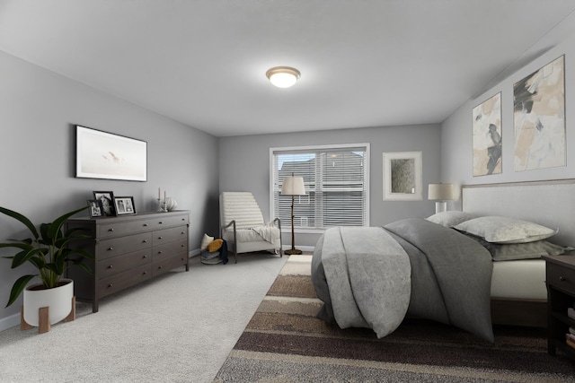 carpeted bedroom featuring baseboards