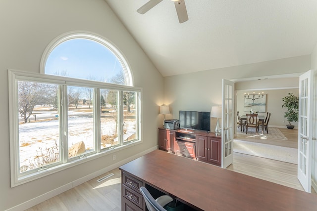 office area with baseboards, ceiling fan, vaulted ceiling, french doors, and light wood-type flooring