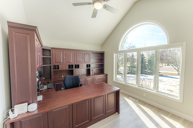 home office featuring visible vents, lofted ceiling, baseboards, and a ceiling fan