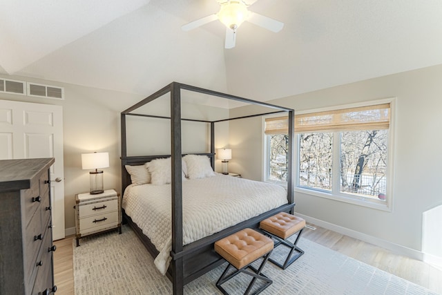 bedroom with a ceiling fan, visible vents, baseboards, lofted ceiling, and light wood-style floors