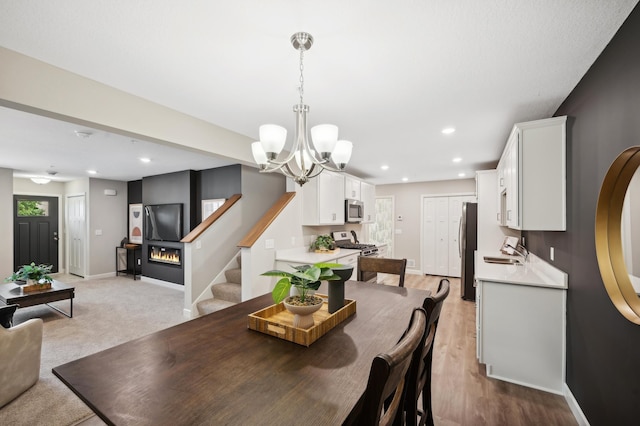 dining room with stairway, recessed lighting, an inviting chandelier, and baseboards