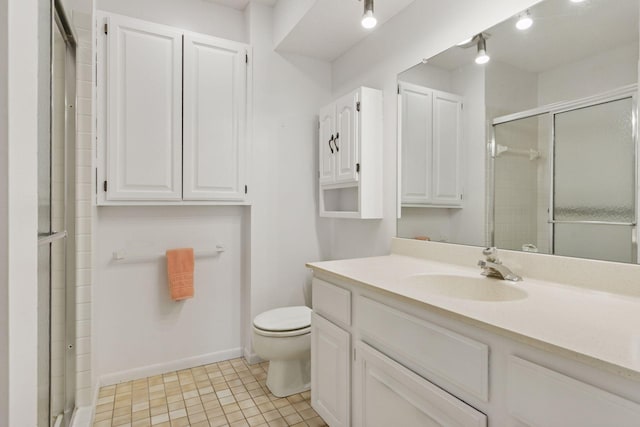 bathroom featuring tile patterned flooring, a stall shower, toilet, and vanity