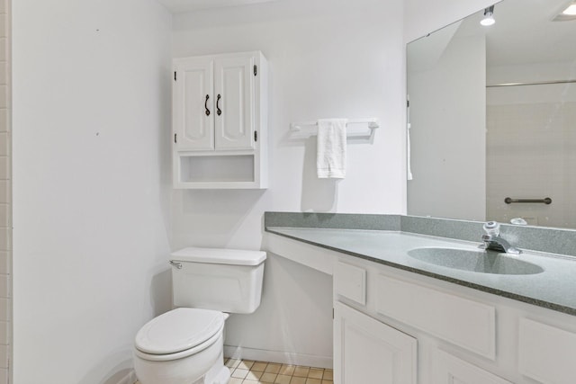 bathroom featuring vanity, tile patterned floors, and toilet