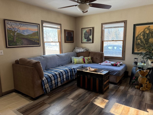 bedroom with multiple windows, wood finished floors, and a ceiling fan