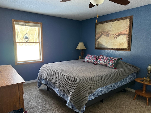 carpeted bedroom with a ceiling fan, a textured ceiling, and baseboards