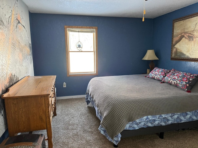 carpeted bedroom with a textured ceiling and baseboards