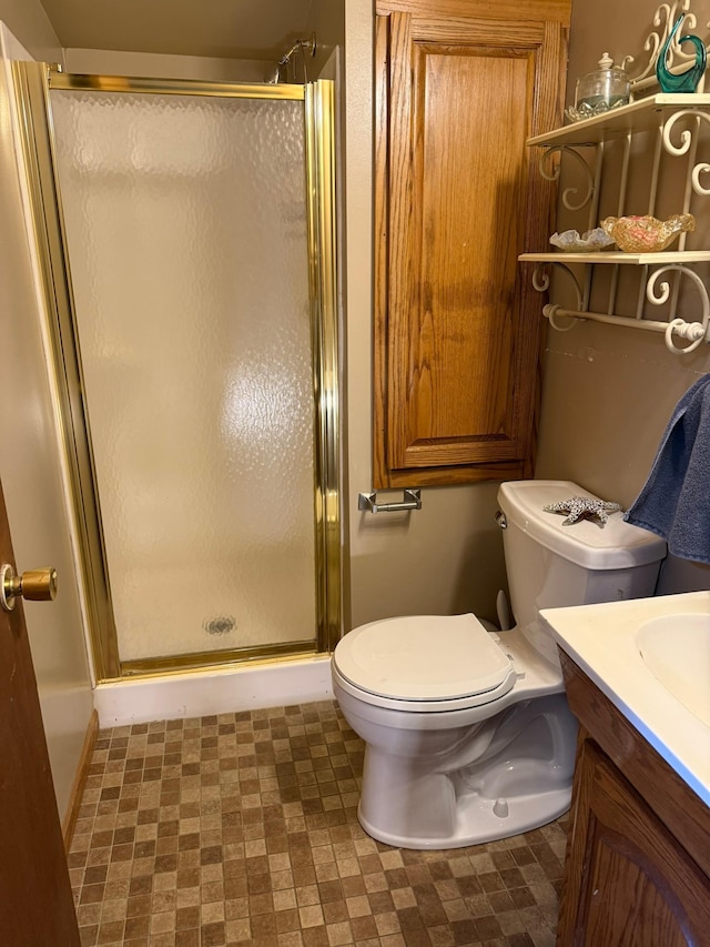 full bathroom featuring toilet, a shower stall, and vanity