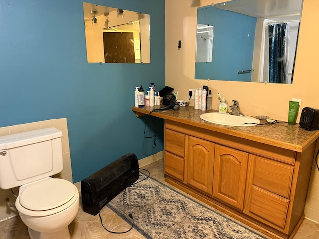 bathroom with vanity, toilet, and tile patterned floors