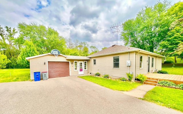 1789 Glynview Trl, Faribault, MN 55021 - view of front facade featuring asphalt driveway, an attached garage, a front yard, and roof with shingles