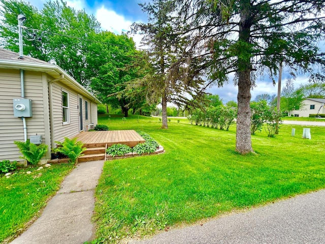 1789 Glynview Trl, Faribault, MN 55021 - view of grassy yard with a wooden deck