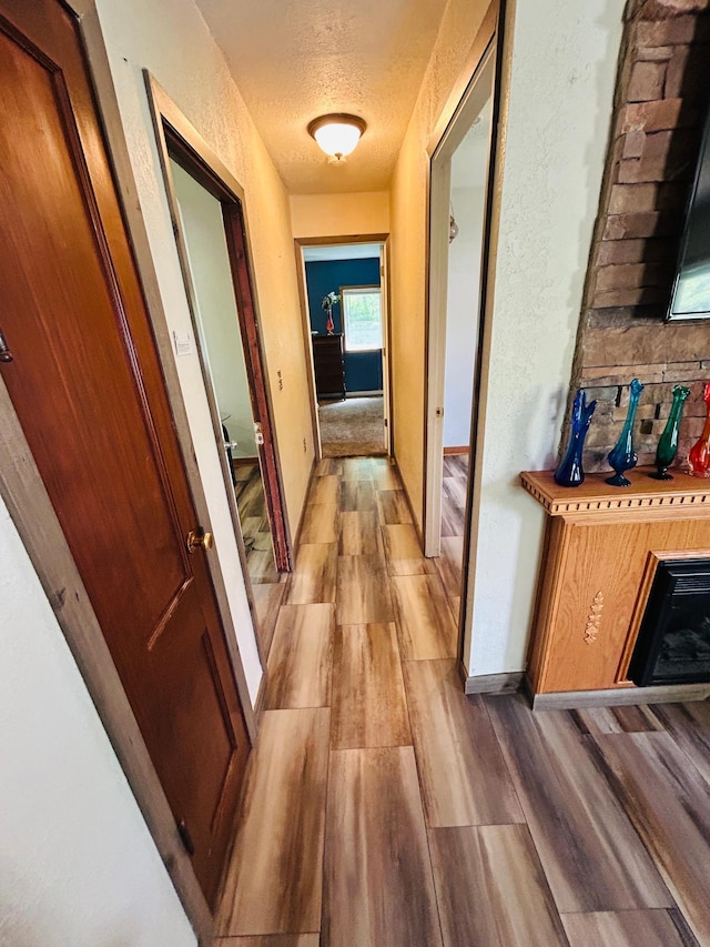1789 Glynview Trl, Faribault, MN 55021 - hall featuring light wood finished floors, a textured ceiling, and baseboards