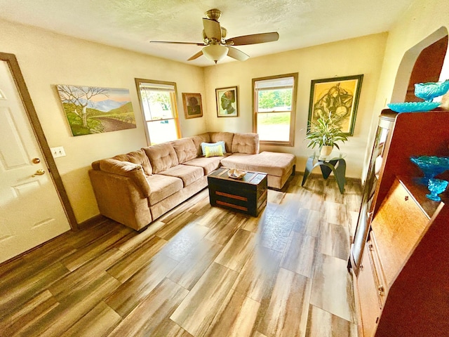 1789 Glynview Trl, Faribault, MN 55021 - living area with ceiling fan, light wood-type flooring, a textured ceiling, and baseboards
