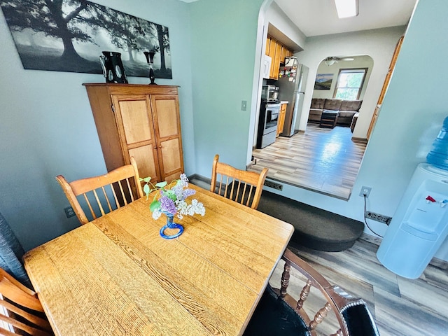 1789 Glynview Trl, Faribault, MN 55021 - dining area featuring arched walkways, light wood-style flooring, and baseboards