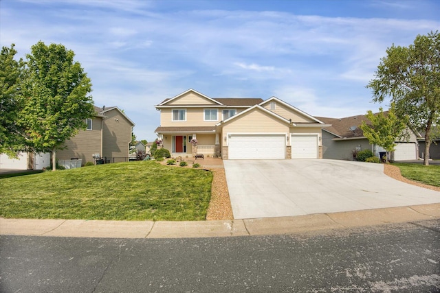 craftsman-style home with a front yard, concrete driveway, and an attached garage