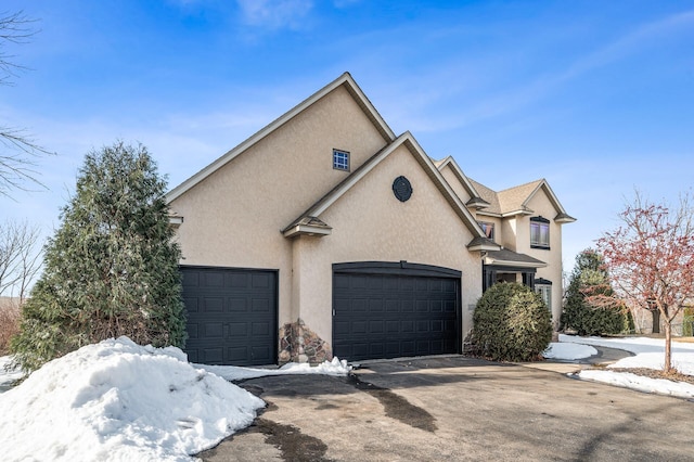 view of front of house with stucco siding and an attached garage