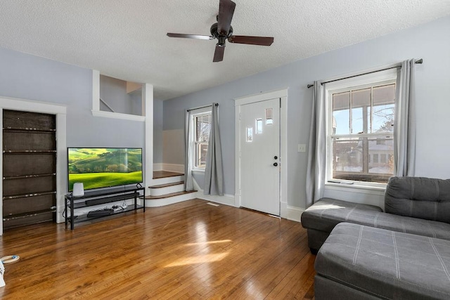 entryway with hardwood / wood-style flooring, plenty of natural light, a ceiling fan, and a textured ceiling