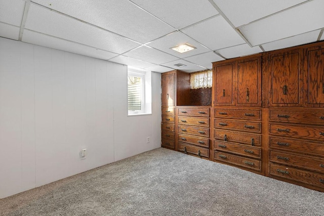 unfurnished bedroom featuring carpet and a drop ceiling