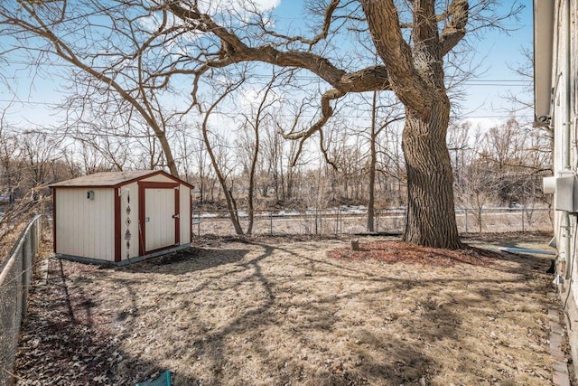 view of yard with an outbuilding, a fenced backyard, and a shed