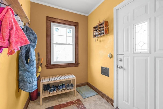 interior space with baseboards and ornamental molding