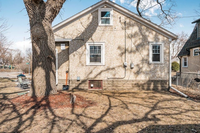 exterior space with fence and stucco siding