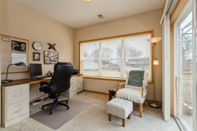 home office with visible vents, baseboards, and light colored carpet