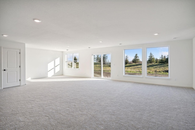 unfurnished room with carpet, baseboards, and recessed lighting