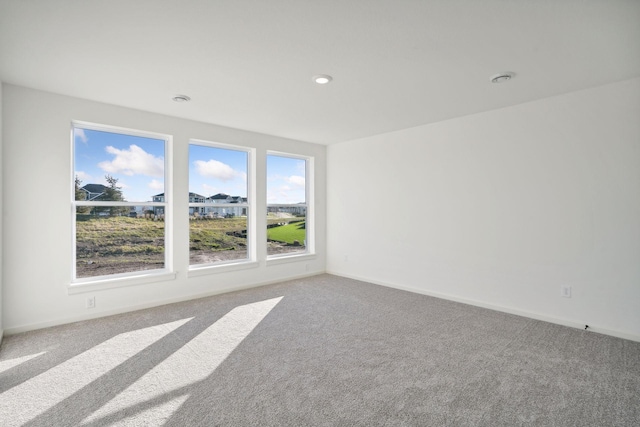 spare room with carpet flooring and baseboards