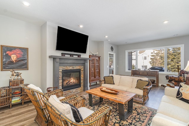 living area featuring recessed lighting, a fireplace, and light wood-type flooring