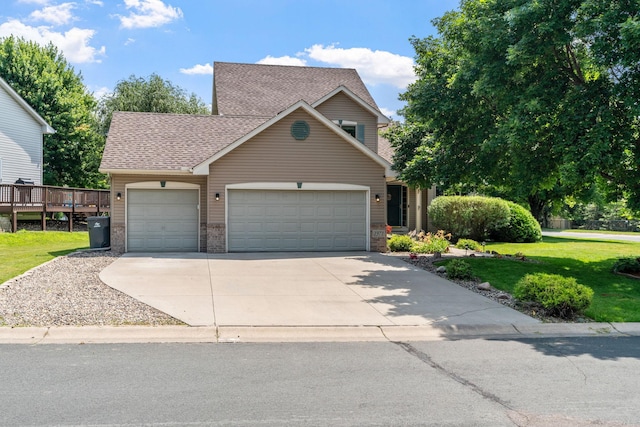 view of front of property with brick siding, a front lawn, concrete driveway, roof with shingles, and a garage