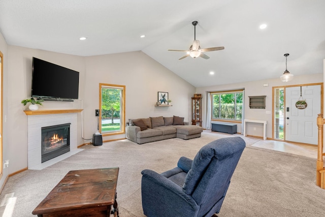 carpeted living room with baseboards, a fireplace with flush hearth, recessed lighting, high vaulted ceiling, and a ceiling fan