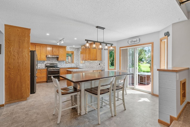 dining area featuring baseboards and a textured ceiling