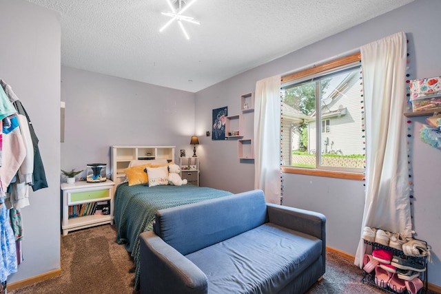 carpeted bedroom featuring baseboards and a textured ceiling