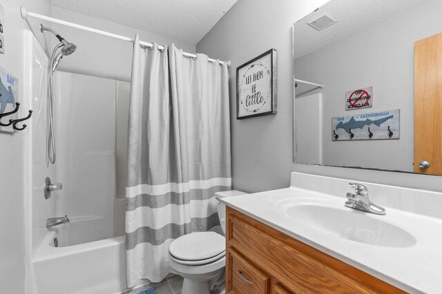 full bath with vanity, toilet, shower / bathtub combination with curtain, and a textured ceiling