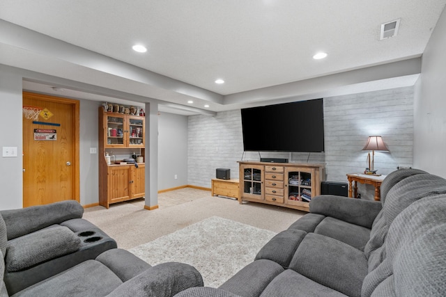 living room with recessed lighting, light colored carpet, visible vents, and baseboards