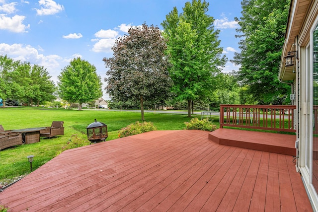 wooden deck featuring a lawn